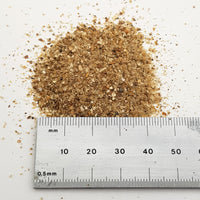 alt="Close up of coarse sand next to a ruler to give an impression of particle size"