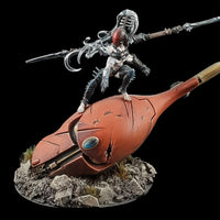 alt="example of a soul gem in use, shown on the forehead of a severed eldar titan head with a dark eldar figure standing atop"