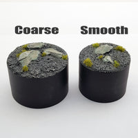 alt="Painted and modelled comparison between coarse and smooth sand on round plinths, because I also sell those and self promotion is important"
