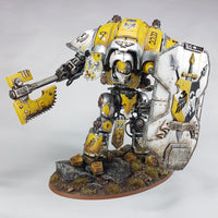alt="painted yellow hawkshroud imperial knight with chain axe combat arm and heraldry breach shield"