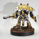 alt="painted yellow imperial knight on a scenic base mounted onto the largest of the oval plinths for reference"