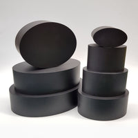 alt="seven black resin oval plinths against white background, stacked into two columns"