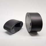 alt="two black resin oval plinths showing the flattened off face on each"