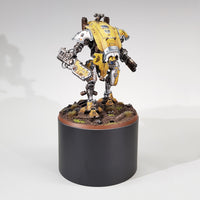alt="one hundred millimetre round plinth shown with a painted yellow imperial knight armiger for scale reference"