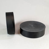 alt="two black resin round plinths showing the flattened off face on each"