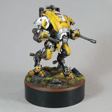 alt="painted yellow imperial knight armiger on a scenic base mounted on a one hundred millimetre plinth for reference"